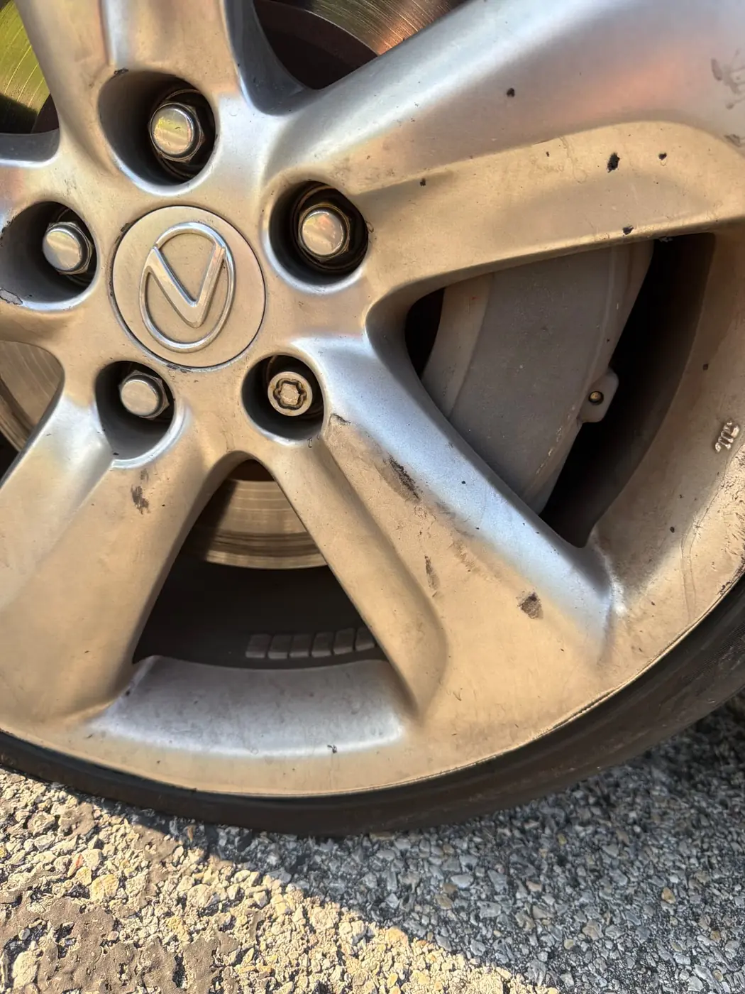 Extraction socket backing a locking lug nut off a Lexus wheel during a mobile wheel lock removal in Dallas-Fort Worth.